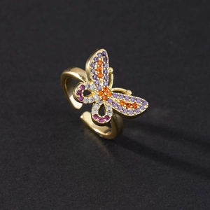 Macro shot of gold butterfly ring with colorful zircons and adjustable open band
