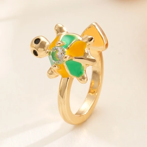 Macro shot of detailed turtle ring with colorful enamel inlay and sparkling center crystal