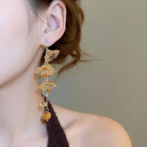 Amber flower resin tassel earrings with crystal pendants on a silver needle post