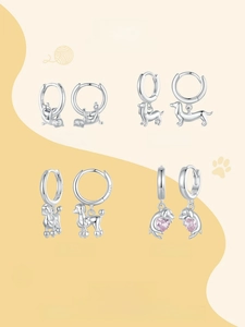 Detail of four S925 sterling silver animal hoop earrings featuring dogs and cats designs