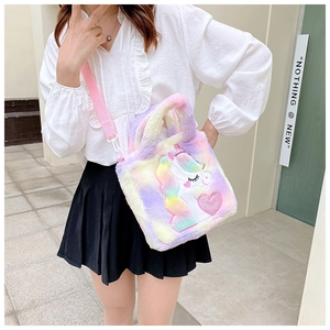 Detail of plush rainbow unicorn bag showing soft texture and adjustable pink strap