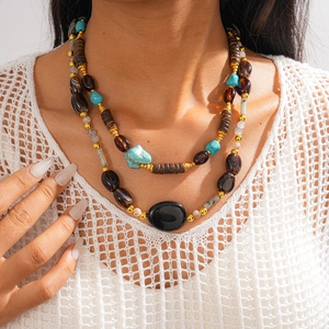 Detailed view of bohemian double-layered necklace with turquoise beads and wood textures