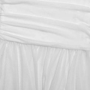 Close-up of white strapless dress featuring layered pleats and delicate tulle fabric texture
