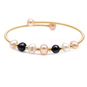 Gold wire wrapped bracelet featuring colorful freshwater pearls and metal beads on white background