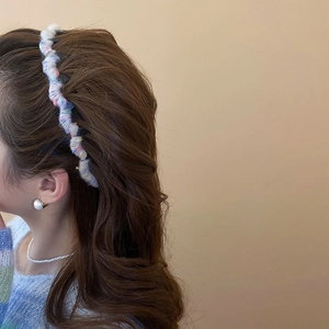 Detail of colorful knit wool headband on model showing soft rainbow pastel textures