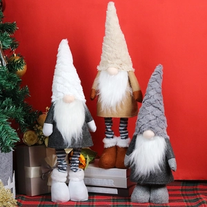 Three plush Christmas gnomes in white, gray, and beige set against a red festive background