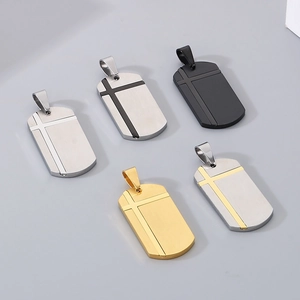 Detailed macro view of five dog tag pendants in multiple metallic finishes and cross design