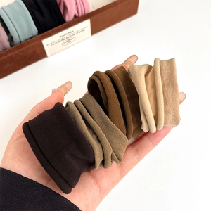 Morandi elastic towel hair ties set in beige and brown shown on hand palm