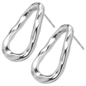 Detailed macro view of silver stainless steel earring with textured hammered surface finish