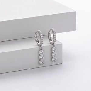 Detail of S925 sterling silver drop earrings with three vertically aligned sparkling crystals
