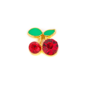 Macro shot of cherry nail art alloy drill with red crystals and green leaves