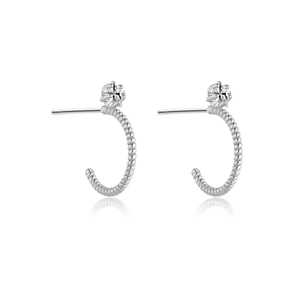 Silver twisted C-shape hoop earrings with sparkling star zircon on white reflective base