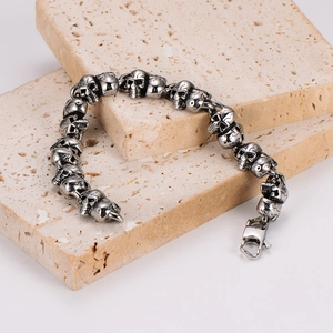 Vintage stainless steel skull link bracelet for men with gothic silver finish and lobster clasp