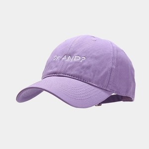 Detail view of the embroidered OK AND text on light purple cotton baseball cap