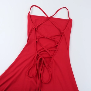 Close-up of sexy red cowl neck dress featuring intricate criss-cross back straps