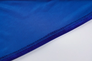 Macro shot of royal blue fabric texture with precise dark blue stitching details