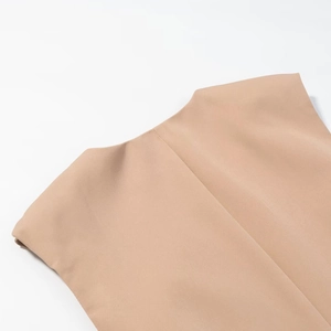 Close-up of khaki woven fabric showing the shoulder seam and fine stitching details
