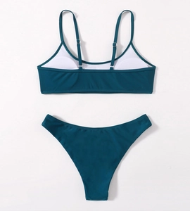 Detail view of dark teal bikini lining, foam pads, and elastic fabric texture