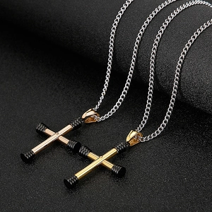Close-up of black and gold vacuum-plated cross pendants on silver necklaces