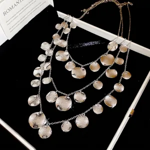 Silver multi-layer necklace with textured metal round pendants for a layered luxury look