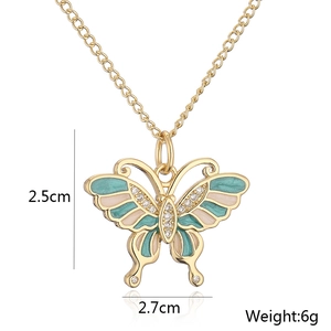 Detail of 18K gold butterfly pendant with green and pink enamel and zircon specs