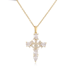 Detail of gold cross pendant with teardrop-shaped zircon stones and central eye motif