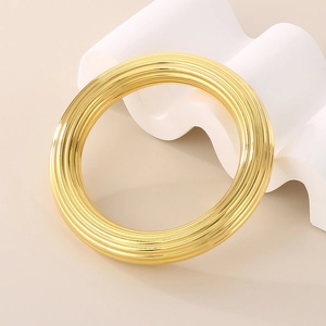 Gros plan du bracelet en acier inoxydable plaqué or 18k avec texture spirale chic