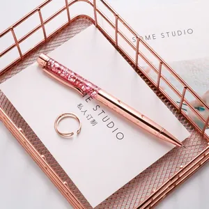 Rose gold ballpoint pen with pink glitter quicksand decor in metal storage basket