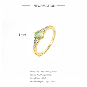 Detail view of 925 sterling silver ring with 5mm green zircon and white side stones