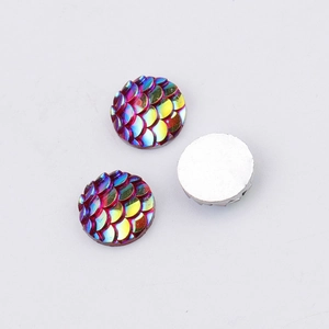Macro shot of 10mm round resin fish scale cabochons with iridescent rainbow finish