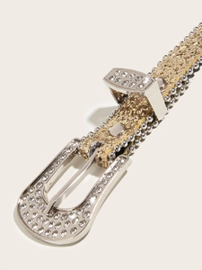 Close-up of golden sequin belt buckle with sparkling rhinestones and silver metal details