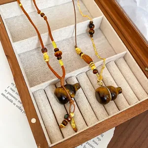 Tiger Eye Stone Gourd Necklace with wooden beads and gold chain in a jewelry display box