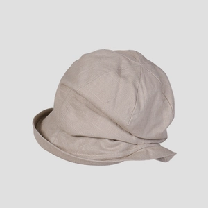 Detailed view of the breathable woven linen fabric texture on this beige sun hat