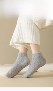 Detail of warm grey coral fleece house socks with non-slip silicone grips on the sole