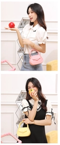 Detailed view of mini PVC jelly bags in pink and yellow with chain straps