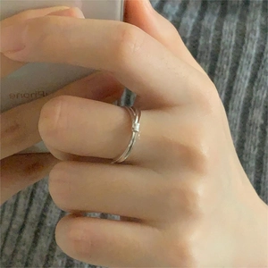 Close-up of minimalist 925 sterling silver bamboo ring with small square detail on finger
