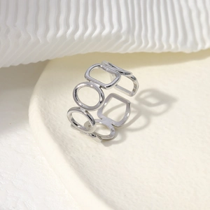 Detail view of silver geometric open ring with interlocking circular frames in macro shot