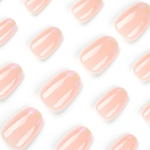 Faux ongles ovales rose aurore brillants avec bouts français à paillettes scintillantes