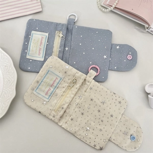 Detail of fabric card holder with star sequins and zipper for coins and ID storage