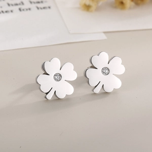 Macro shot of silver clover earrings featuring polished finish and center cubic zirconia