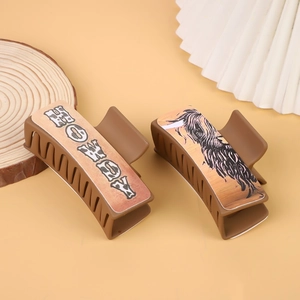 Detail of matte brown hair claws with Western Howdy and Highland Cow graphics