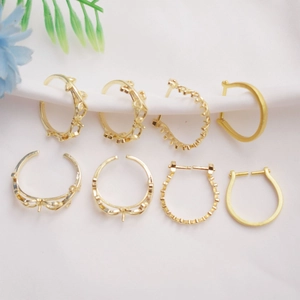 Detail of 14K gold plated C-shaped leaf and heart earring hooks for DIY pearl jewelry