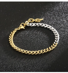Detail of two-tone gold and silver Cuban link bracelet with lobster clasp and extension