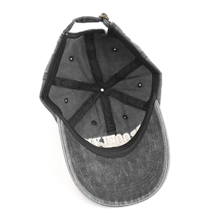 Detail of vintage washed cotton baseball cap showing adjustable bronze metal buckle and sweatband