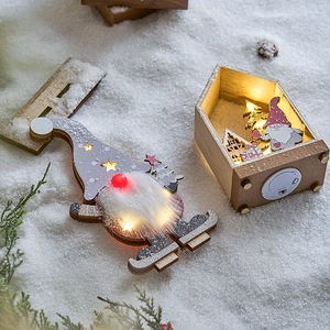 Illuminated wooden Christmas scene with Gnome and LED cabin ornaments on snow decor