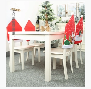 Detailed view of Christmas chair covers with Santa and snowman prints in a dining setting