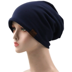 Navy blue breathable slouchy beanie with a brown leather F&S logo tag for casual wear