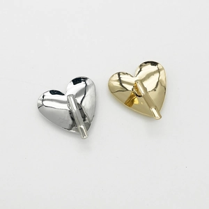 Polished heart-shaped metal hair hooks in silver and gold with smooth mirror finish