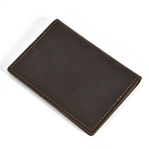 Detailed view of dark brown crazy horse leather card holder with light contrast stitching