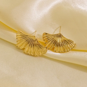 14K gold-plated stainless steel ginkgo leaf stud earrings on elegant silk background